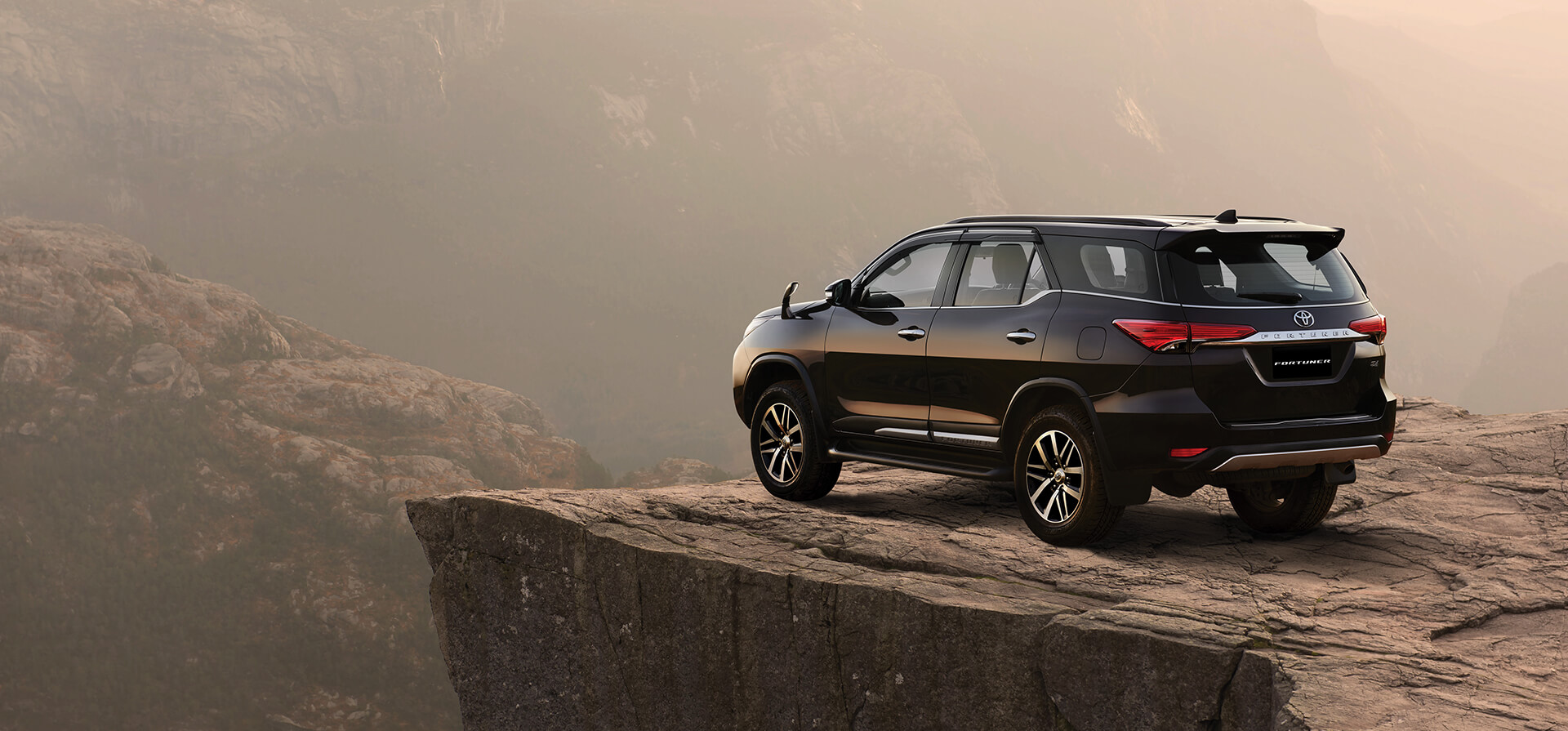 Download Toyota Fortuner Black Legender Suv Wallpaper | Wallpapers.com